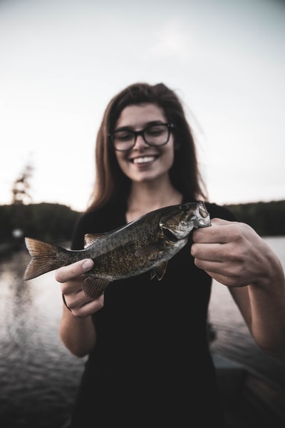 Women with grey fish
